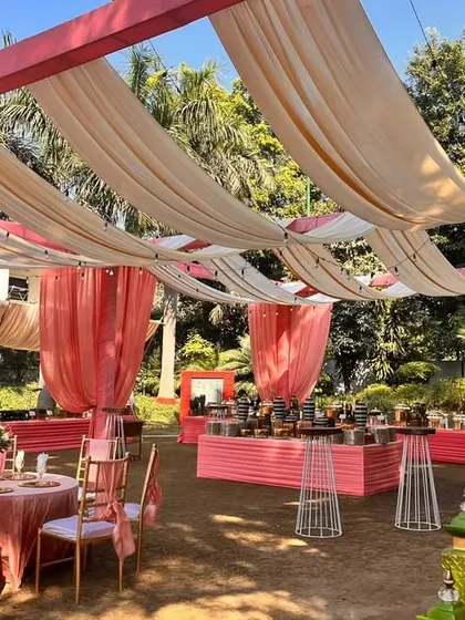The entire event space was draped in soft, flowing fabrics in shades of peach and cream, creating a light and airy pergola for this beautiful outdoor celebration.
