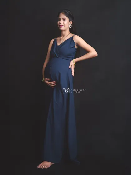 A confident full-length pose in a navy blue jumpsuit, offering a modern and stylish alternative to a traditional gown.