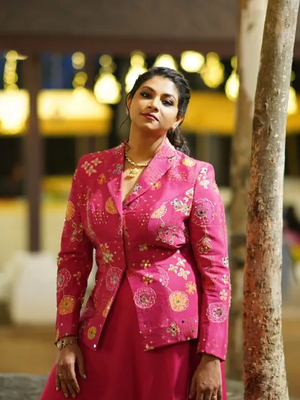 The stunning Shrusti Patil in a fabulous pink suit, featuring a hand-embroidered jacket over a flowing skirt.