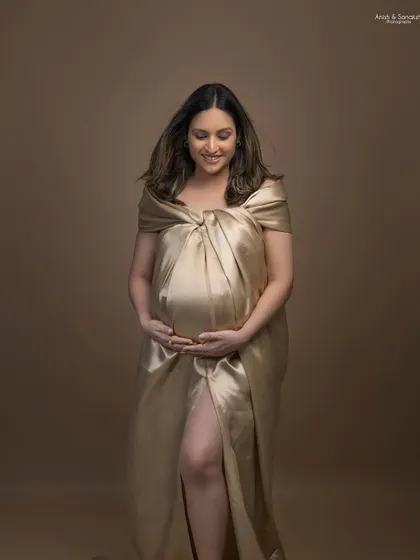Another elegant look from the same maternity shoot. The simple makeup and hair allow the unique satin draping and her pregnancy glow to be the main highlights.