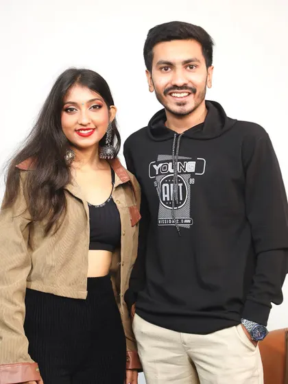 A photo with the host after recording a podcast. I enjoy these opportunities to connect with other creators and share my journey in the music world.