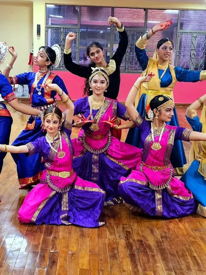 A group of my students posing in colorful Bharatanatyam and Kathak costumes during a rehearsal for the Delhi Literature Fest.