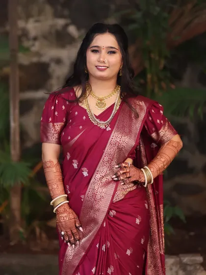 A stunning portrait of bride Mansi. Her makeup features a slightly bolder eye and lip to match the rich tone of her maroon saree.
