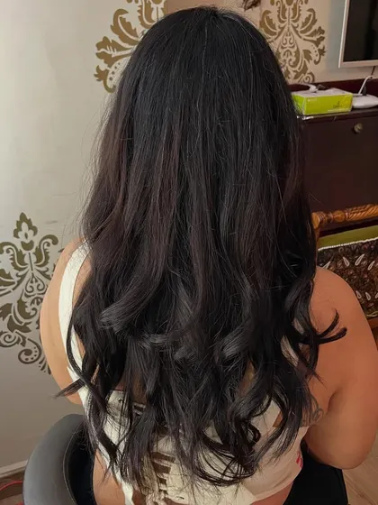 Long layers and wispy bangs for Supriya.