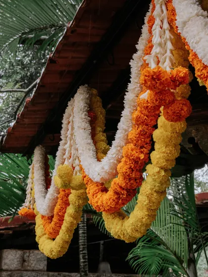 Close-up of traditional marigold and tuberose garlands used in our decor.