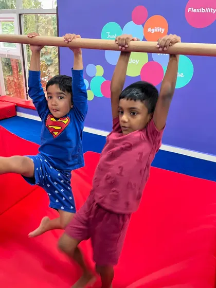 Two buddies working on their bar skills together. Our classes encourage peer support and friendship, creating a positive and motivating environment for everyone.