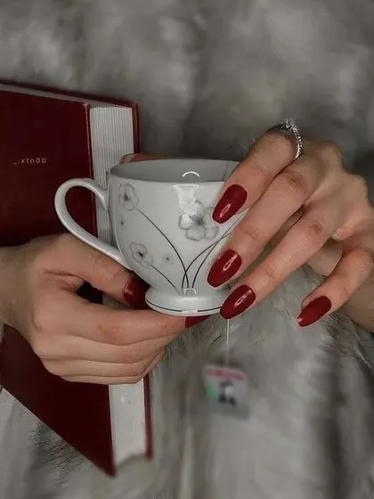 This weather calls for a nice book, a hot cup of tea, and a perfect set of classic red nails.