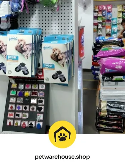 From doggy socks and accessories to large bags of premium pet food, our store is organized to help you find exactly what you're looking for. A staff member is seen here stocking the shelves.