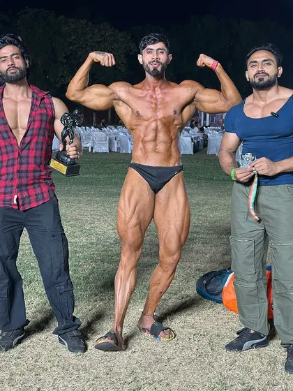 Showing off the hardware. This is the reward for months of strict dieting and intense training.