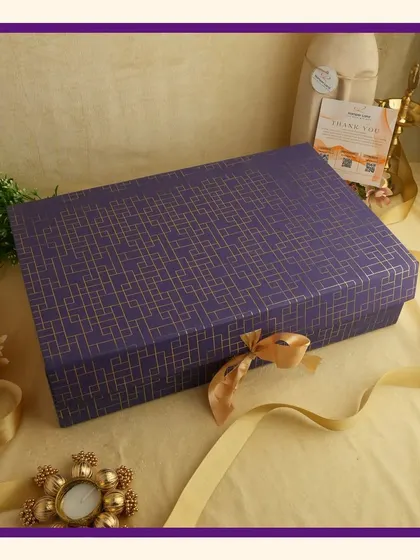 A fully closed royal purple gift box with a gold ribbon, showcasing the elegant exterior packaging of my festive hampers.