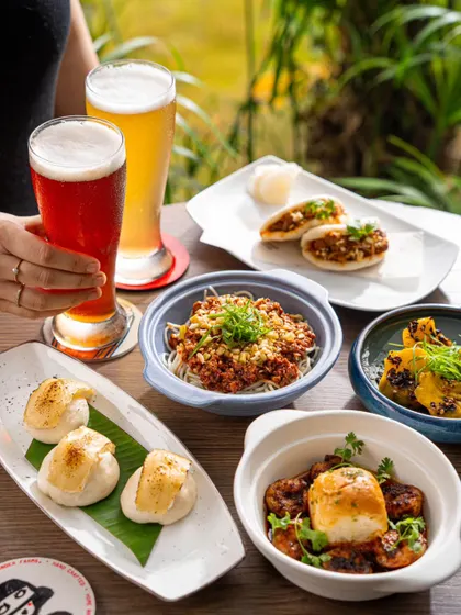 A table scene at a brewery, with a focus on the food and beer pairings.