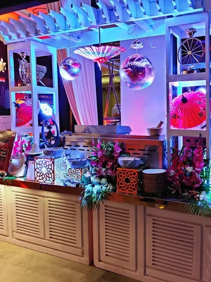 The same satay station seen under dramatic event lighting. We work with event planners to ensure our setups integrate seamlessly with the overall decor and theme of the evening.