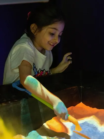 The smile of discovery while playing with the illusion sand. It's a truly unique and engaging sensory activity.