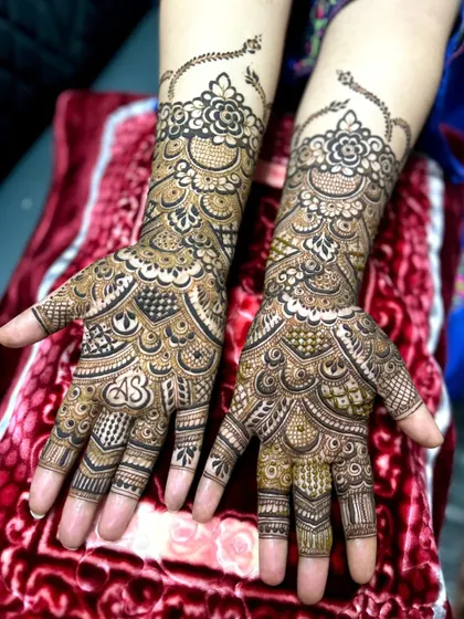 A classic bridal design featuring the couple's initials 'AS' elegantly placed on the palm, surrounded by traditional motifs.