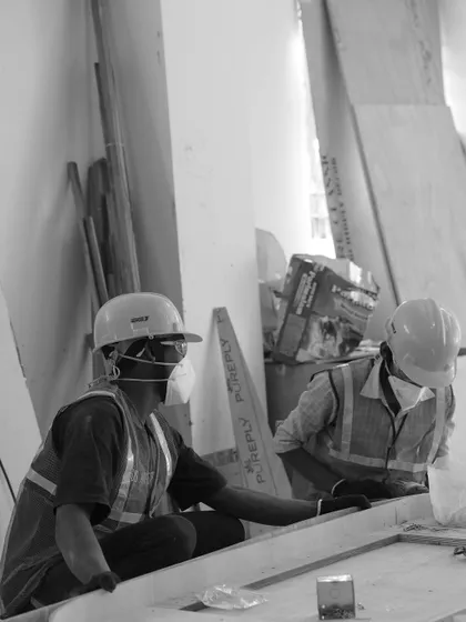 A black and white shot of our carpenters at work. Woodworking is a critical part of our interior build-outs, and we rely on the skill of our dedicated team.
