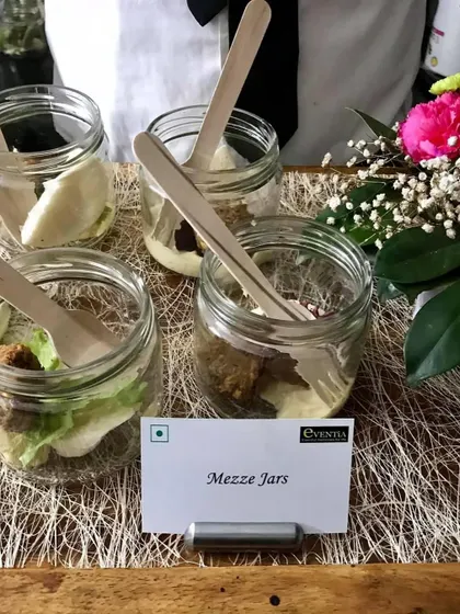 Welcoming the harvest season with a cozy Lohri celebration. These Mezze Jars, filled with delicious layers, are a modern and convenient way to serve appetizers at your private party, letting you enjoy the warmth of the bonfire.
