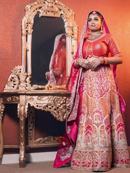 The full view of the red sequined lehenga, showing the intricate architectural patterns on the skirt. A true statement piece for any bride.