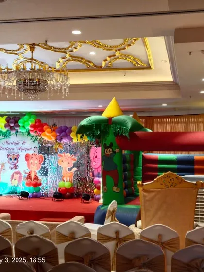 A wide angle view of the banquet hall, showing our jungle theme decor and bouncy castle setup.