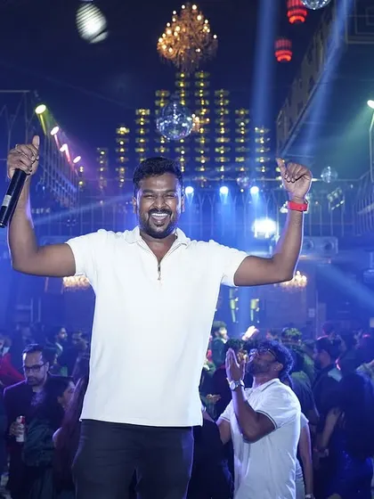 Commanding the stage and hyping up the crowd is what I do best. This shot captures the peak energy of a corporate celebration, where my role as an MC is just as important as the music I play.