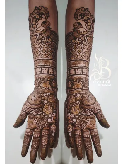 I believe mehndi is the most beautiful jewelry. This design shows my love for detailed traditional work, featuring symmetrical peacocks, fine jaali net patterns, and auspicious swastika symbols for a classic bridal style.