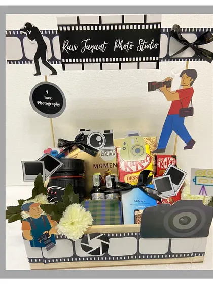 A perfect gift for the shutterbug in your life. This photography-themed hamper is creatively designed with camera and film strip motifs and filled with treats for a picture-perfect celebration.