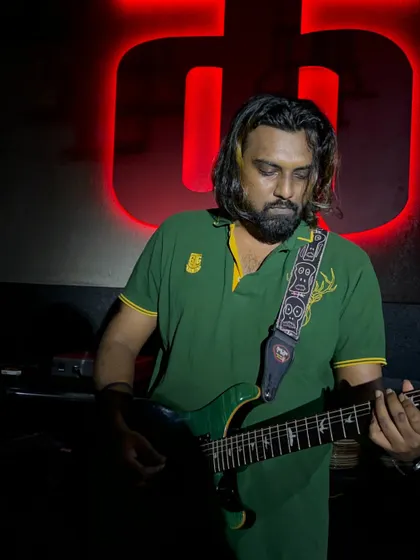 Another shot of our guitarist, lost in the music. He brings the magic with every strum.