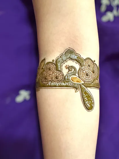 A delicate peacock arm band, perfect as a standalone piece or part of a larger design.