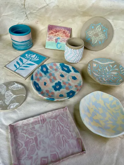 Another angle of the vibrant, finished student pieces. This image highlights the diverse styles, from floral patterns and marbled effects to intricate mandala designs.