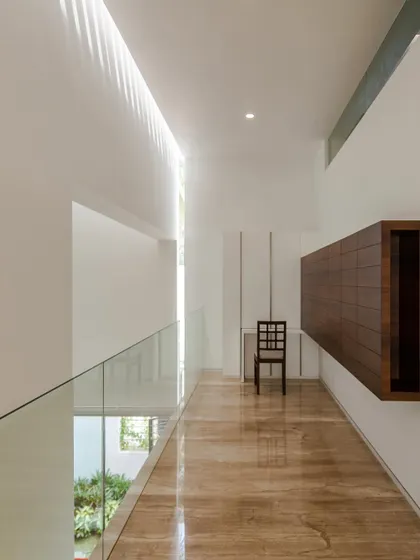 A long skylight illuminates the upper floor hallway, creating a bright, gallery-like space.