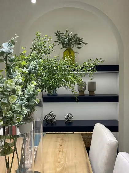 An arched wall niche with floating shelves creates a sophisticated display area. I focus on properties with unique architectural features that add personality and charm.