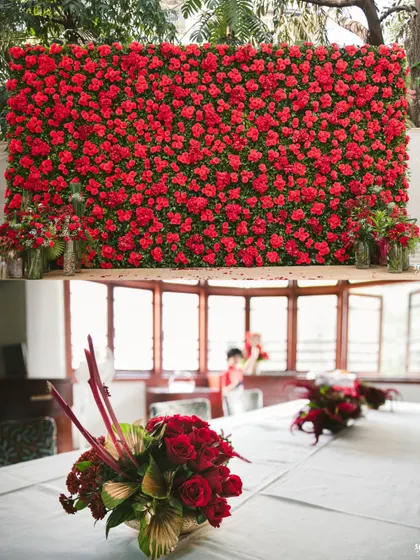 A closer look at a magnificent wall of red roses, perfect as a stage backdrop or a photo wall. The lower panel shows how the theme extends to table centerpieces.