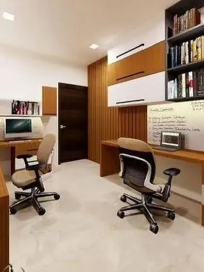 A full-fledged home office for two with extensive shelving and individual workspaces to maximize productivity.