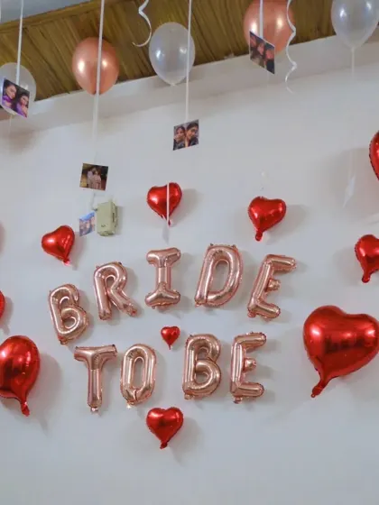 This setup includes balloons with photos hanging from them, adding a personal and sentimental element to the bachelorette party decor.