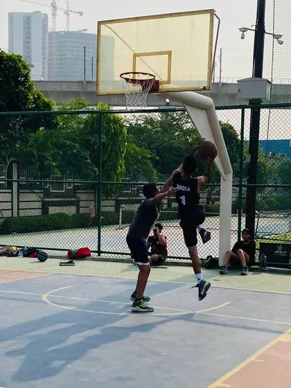 A contested jump shot near the basket shows the competitive intensity of our training sessions.