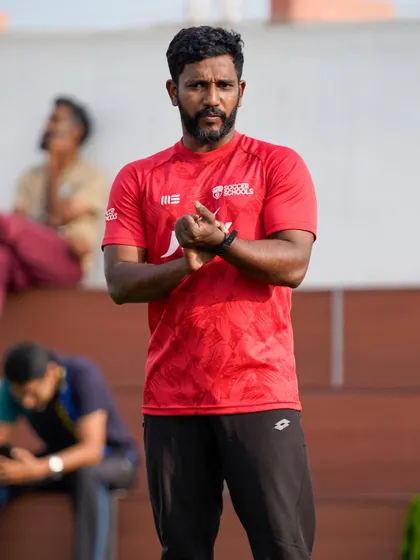 A coach claps in encouragement during a drill. We believe positive reinforcement is key to building a child's confidence and fostering a lifelong love for the sport.