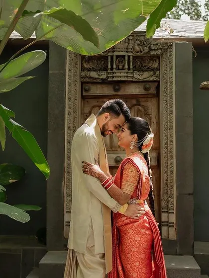 A quiet, intimate portrait framed by lush greenery. We use natural elements to create a sense of romance and tranquility in our couple's wedding photos.