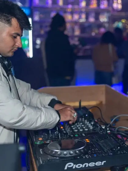 Here's a shot of one of my talented DJs at the Pioneer console, expertly mixing tracks to create a seamless flow of music for the dance floor.