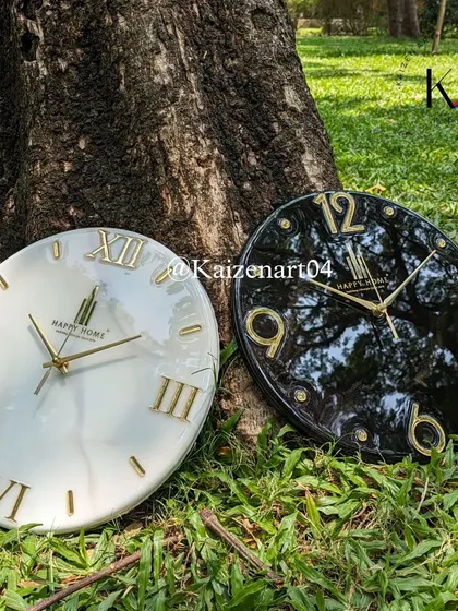 Branding is key, and a custom clock is a great way to display it. Here are two examples of branded wall clocks, one in white marble and one in black marble, both featuring a company logo and offering a classy touch to any office space.