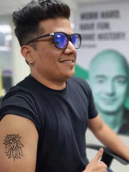 A temporary tattoo of a lion's head with a floral mane, perfect for a corporate event.