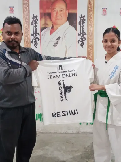 Presenting a customized team t-shirt to one of my dedicated students, Reshmi, before we left for the tournament.