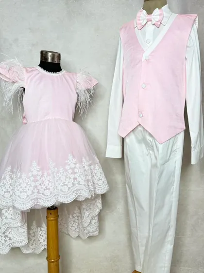 Pretty in pink and white for a special occasion. This brother-sister set features a girl's dress with delicate feather and lace details, and a boy's matching pink waistcoat.