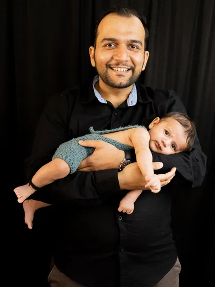 A proud father holding his baby. These portraits are so important, celebrating the new role of 'Dad' and the special bond he shares with his child.
