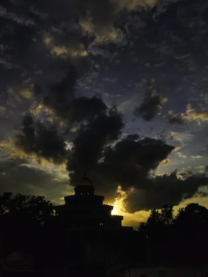 The silhouette of the Vishalakshi Mantap against a dramatic sunset sky. Just as nature's colors change, our moods also shift, but our true self remains the constant, silent witness.
