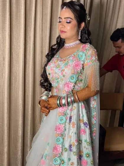 A gorgeous sangeet look in a pastel floral lehenga. The makeup has soft lilac tones on the eyes to complement the outfit.