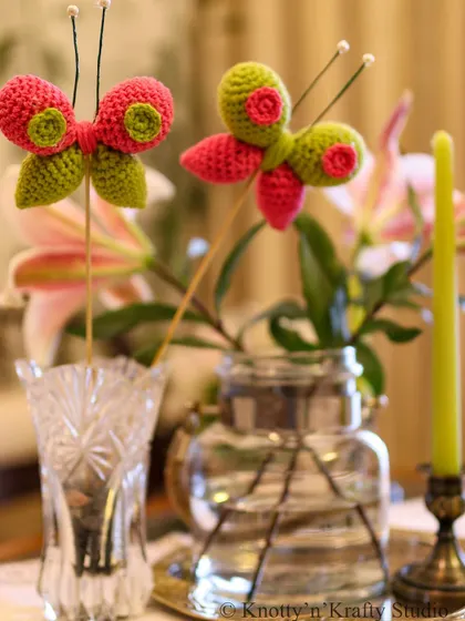 The Happy Butterflies, adding a touch of whimsy to a simple arrangement of glass vases.