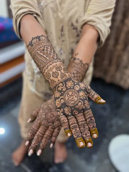 This set shows a popular style with a central personalized element, surrounded by floral and geometric patterns that extend up the arm.