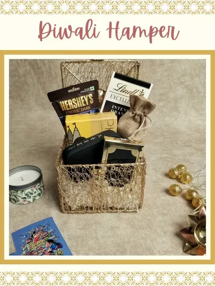 This rustic and charming Diwali hamper is presented in a golden wire basket. It's filled with premium chocolates, an eyewear case, a scented candle, and other curated items.