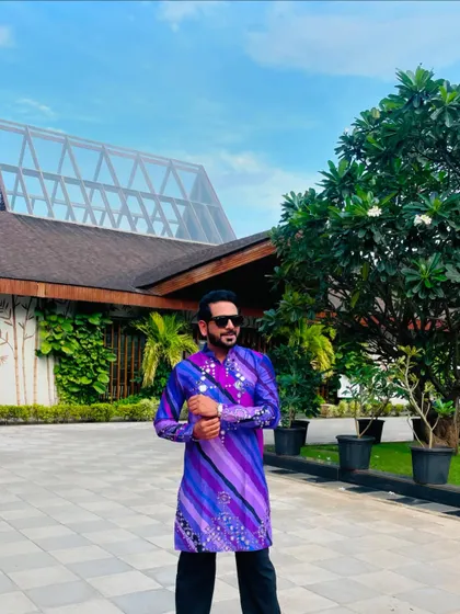 A quick pose in a stunning purple striped kurta before a long day of travel and hosting a Garba Utsav.