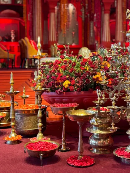 Details from our temple-inspired wedding design, featuring traditional brass diyas and thaals filled with sindoor and fresh flowers. We source authentic elements to create a truly spiritual ambiance.
