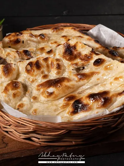 This shot of a plain naan is all about texture. I used specific lighting angles to bring out the charred bubbles and soft, fluffy texture of the bread, making a simple item look delicious.